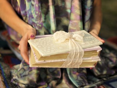 book with a white envelope tied with lace ribbon