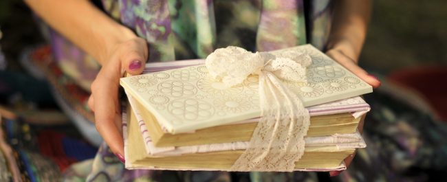 book with a white envelope tied with lace ribbon