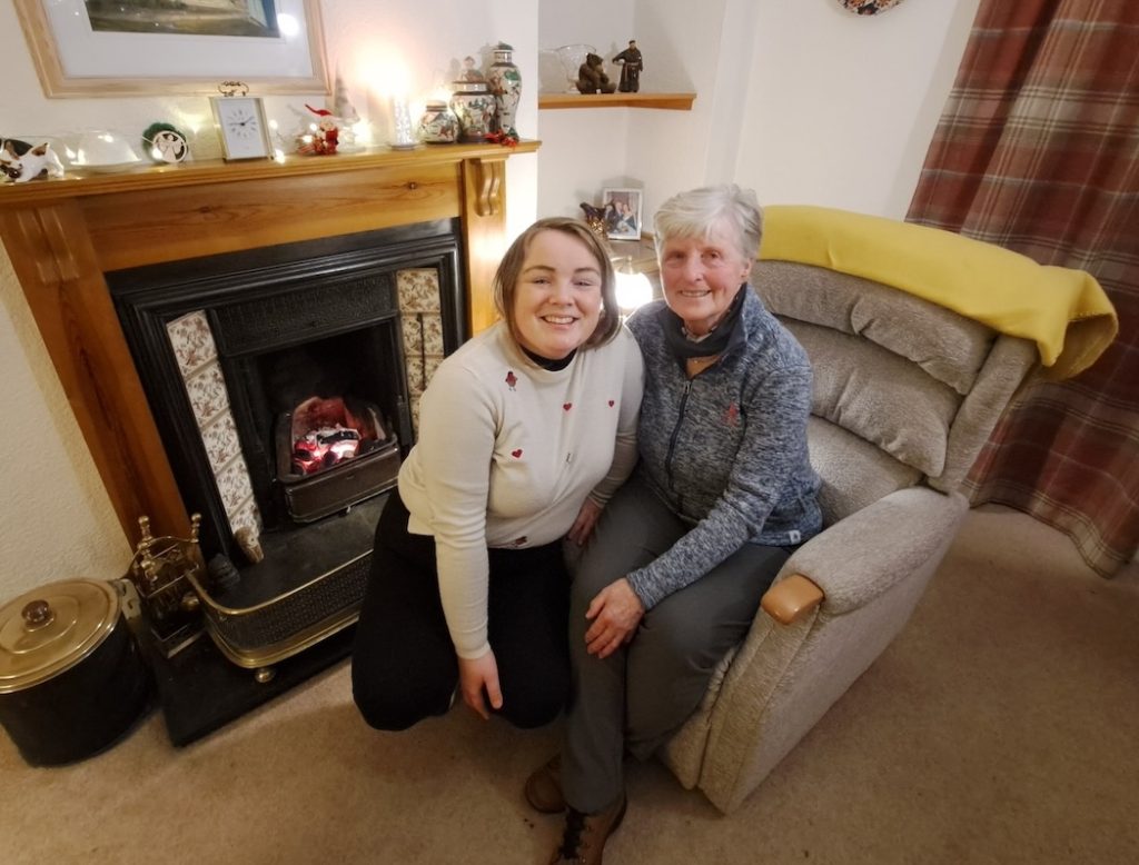 Dorothy and Louise sat together on an armchair by the fire.