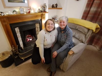 Dorothy and Louise sat together on an armchair by the fire.